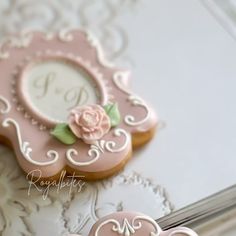 two decorated cookies sitting on top of a table next to each other in front of a mirror