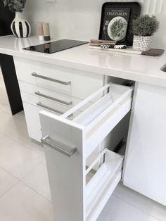 an open drawer in the middle of a kitchen counter