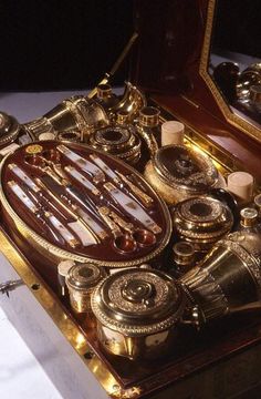 an elaborately decorated wooden box with gold trimmings