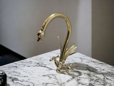 a golden dragon sculpture on top of a marble counter