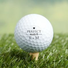 a white golf ball sitting on top of a wooden tee