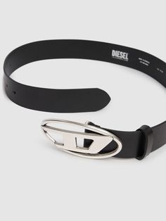 a black belt with a metal buckle on the bottom and an emblem on the side