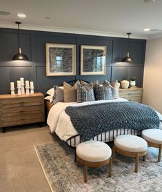 a bedroom with gray walls and white bedding