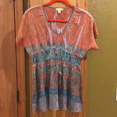 Nwot Live And Let Live Multi-Colored Short Sleeved Top. Size M. This Top Would Be Great For Dinner Or A Night On The Town! Colors On It Are Orange, Gold, Green And Turquoise With Cooper And Silver Threading Throughout Top. It Is In Excellent Condition ( No Stains, Snags Or Rips Anywhere). Measures 19" From Under Arm To Waist With A 2 1/2 To 3" Band Just Under Breast That Goes Into A Loose Fitting, Flowing Bottom. Comes From Smoke Free Home. Live And Let Live, Green And Turquoise, Orange Gold, Threading, Multi Colored, Short Sleeves Tops, Loose Fitting, Womens Tops, Turquoise