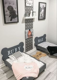 two beds in a room with pictures on the wall