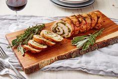 sliced meat with herbs on a cutting board