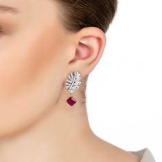 Inspired by Mother Nature, the delicate leaf motif is adorned with sparkling zircons. One side is graced with pave-set zircons, while the other side shines with marquis-cut stones, creating a striking balance of sparkle and sophistication. Suspended beneath this elegant leaf is a mesmerizing square-cut lab-grown Ruby, attached by a corner to create a distinctive diamond shape. Known for its rich, red hue, Ruby is the birthstone for July. This enchanting gemstone symbolizes passion, protection, a Elegant Ruby Diamond Earrings For Wedding, Elegant Red Diamond Earrings, Elegant Ruby Earrings With Diamond Accents, Elegant Ruby Earrings With Brilliant Cut, Elegant Silver Ruby Diamond Earrings, Elegant Bridal Earrings With Single Cut Diamonds As Gift, Elegant Ruby Bridal Earrings, Elegant Single-cut Diamond Bridal Earrings, Elegant Ruby Earrings