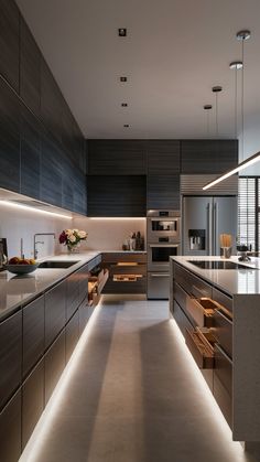 a modern kitchen with stainless steel appliances and counter tops, along with an island in the middle