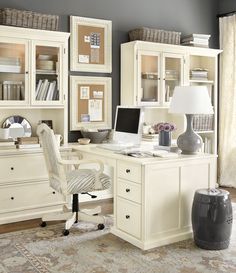 a home office with white furniture and gray walls