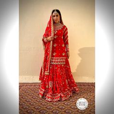 a woman in a red bridal outfit