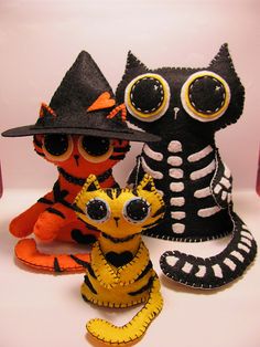 three stuffed animals are dressed up as witches and skeletons for the day of the dead