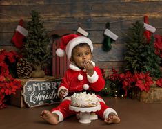 a little boy sitting in front of a christmas cake