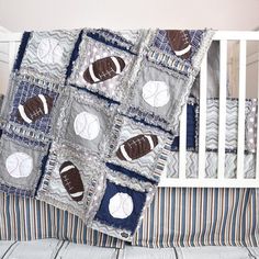 a baby crib bed with a quilted football and ball design on the coverlet