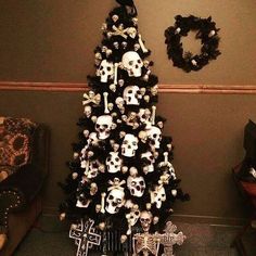 a christmas tree decorated with skulls and wreaths