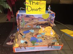 the desert is made out of cardboard and has people in it with signs on them