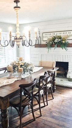 a dining room table with chairs and a chandelier