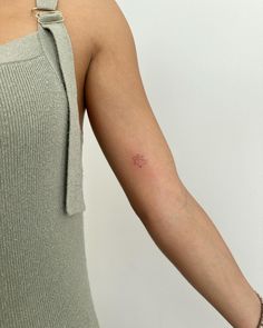 a woman with a small tattoo on her arm