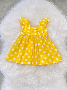 "Beautiful Big Bow Girls dress. Back has elastic for comfort and a great fit. The listing is for one bow dress!  These are the APPROXIMATE measurements of the dresses from shoulder to hem: size/chest/length 0-3m / 14\"/13\" 3-6m /16/14\" 6-9m /17\"/15\" 9-12m /18\"/16\" 12m-18m /19\"/17.5\" 18m-24m /20\"/19\" 2t /21\"/20\" 3t /22\"/20.5\" 4t / 23\"/22\" 5t /24\"/23\" 6y / 25\"/24\" 7y / 26\"/25\" 8y /27\"/26\" Please note: Due to variation in each computer monitor there may be slight differences between the photo shown and the actual item. Care Instructions: Fabric is 100% cotton.  Hand wash or wash on delicate cycle cold water. Hang dry or lay flat. Iron if needed. ATTENTION: This item contains small parts that can pose a choking hazard to young children and infants. Never allow your chil Summer Cotton Dresses With Bow Print, Cotton Summer Dresses With Bow Print, Summer Cotton Dress With Bow Print, Cute Cotton Dress With Bow Tie Back, Cute Polka Dot Dress With Ruffles, Yellow Spring Dress With Bow, Playful Polka Dot Fitted Dress, Yellow Fitted Dress With Flutter Sleeves, Cute Polka Dot Cotton Dress