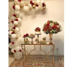 a table topped with lots of white and red balloons