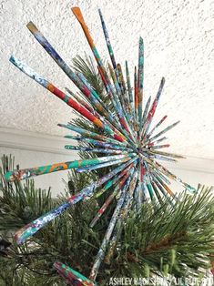 an ornament made out of toothbrushes hanging from a christmas tree