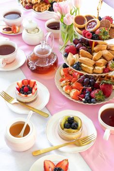 there are many desserts on the table with cups and saucers next to each other