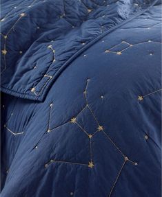 a blue comforter with gold stars on it