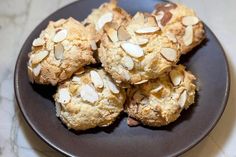 a plate full of cookies with almonds on top