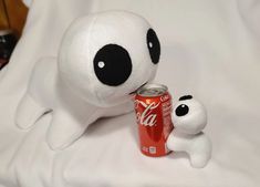 a stuffed animal with a can of coca - cola