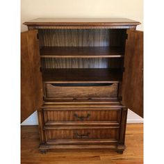 an antique bookcase with drawers is shown