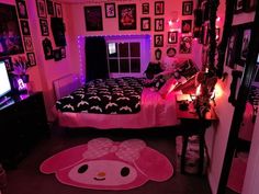 a bedroom decorated in pink and black with pictures on the wall