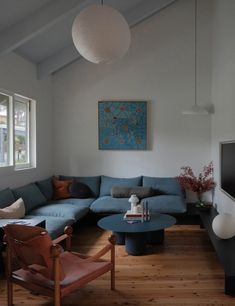 a living room filled with furniture and a flat screen tv mounted on the wall next to a window