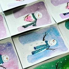 several watercolor paintings of snowmen on paper