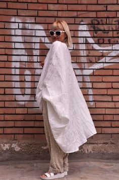 White Long Sleeve Flowy Kimono, White Flowy Long Sleeve Kimono, Summer Lagenlook Tunic With Batwing Sleeves, Spring Lagenlook Tunic With Batwing Sleeves, White Flowy Kaftan For Daywear, White Relaxed Fit Linen Tunic, White Oversized Tunic Kaftan, Oversized Summer Kimono For Daywear, Oversized White Tunic Kaftan