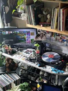 a record player sitting on top of a desk next to a laptop