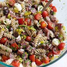 a bowl filled with pasta salad on top of a table