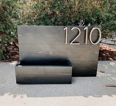 a bench made out of wood with the number 1210 on it's side