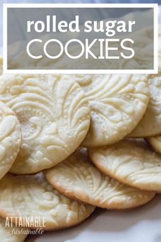 a pile of rolled sugar cookies sitting on top of a white plate with the words, rolled sugar cookies