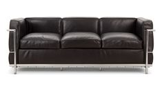 a black leather couch sitting on top of a metal frame