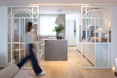 a blurry image of a person walking through a living room and dining room area