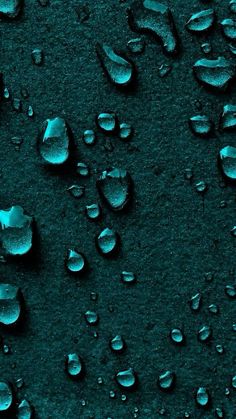 drops of water on the surface of a dark blue background with green highlights and black edges