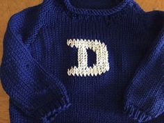 a blue sweater with the letter d on it