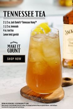 an advertisement for tennessee tea with lemons in the foreground and a bottle of whiskey behind it