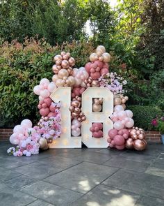 a large letter decorated with balloons and flowers