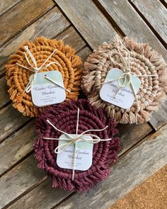 three round baskets tied with twine on top of a wooden table