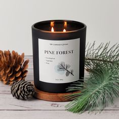 a candle that is sitting next to pine cones