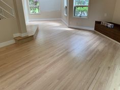 an empty living room with hard wood floors