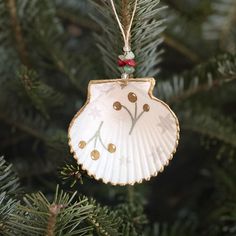 a shell ornament hanging from a christmas tree