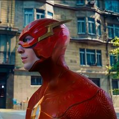 the flash is standing in front of a building