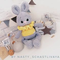 a stuffed animal sitting on top of a table next to cupcakes and cookies