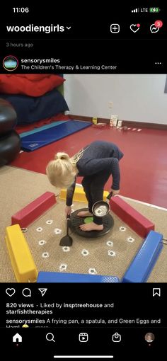 a child is playing with toys on the floor